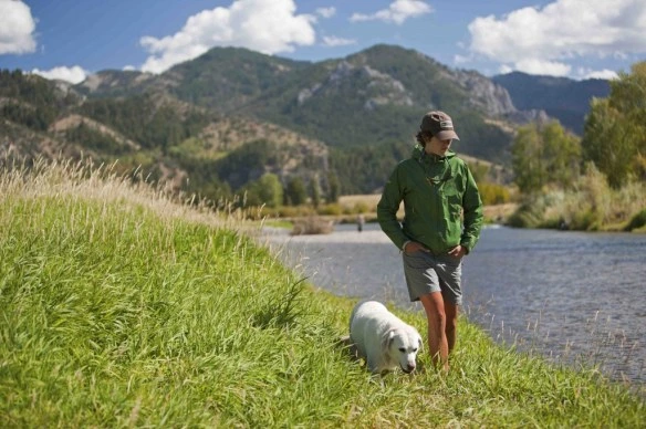 Man wearing Mountain Khakis Original Mountain Pants while hiking through rugged terrain